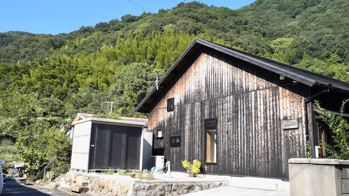 An atmospheric wooden building nestled in the lush green nature of the mountains.