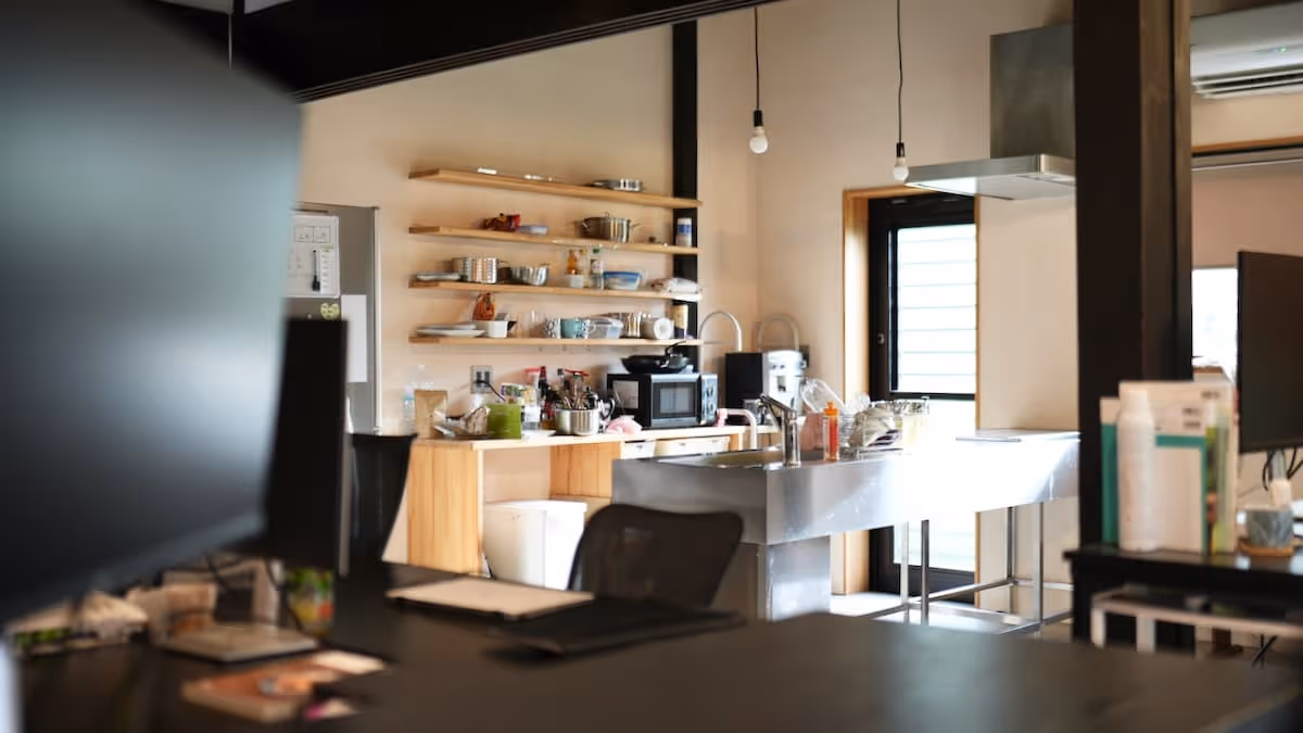 Light shines through the window in this bright kitchen. The work space is large and comfortable.