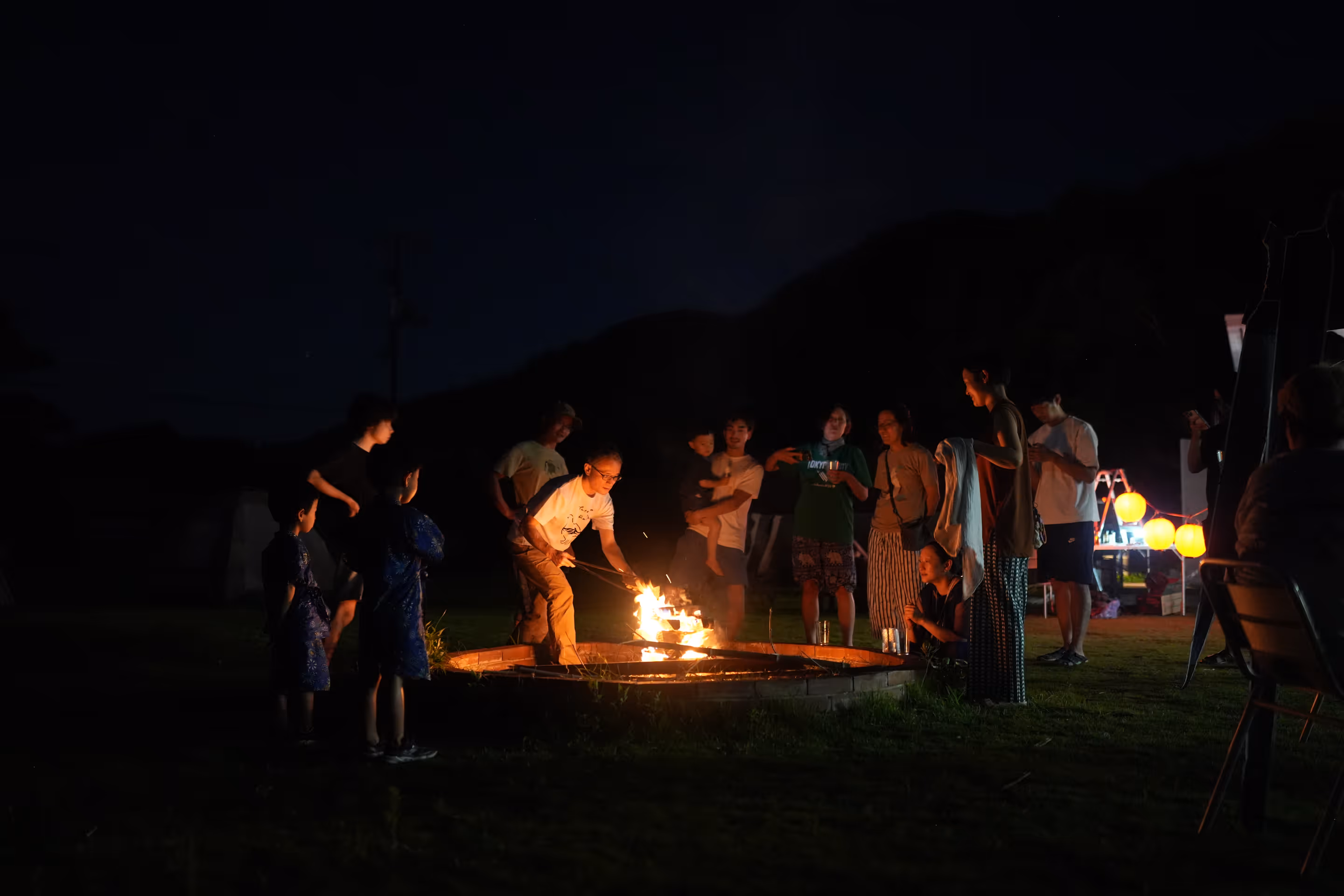 Building their own campfire on a company trip to Suo Oshima.